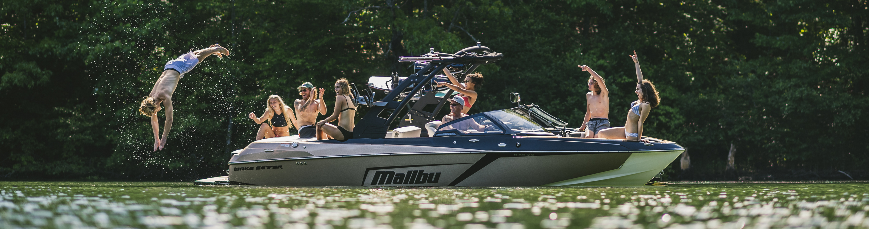 A group of people enjoying their time on a Malibu® boat out on the river